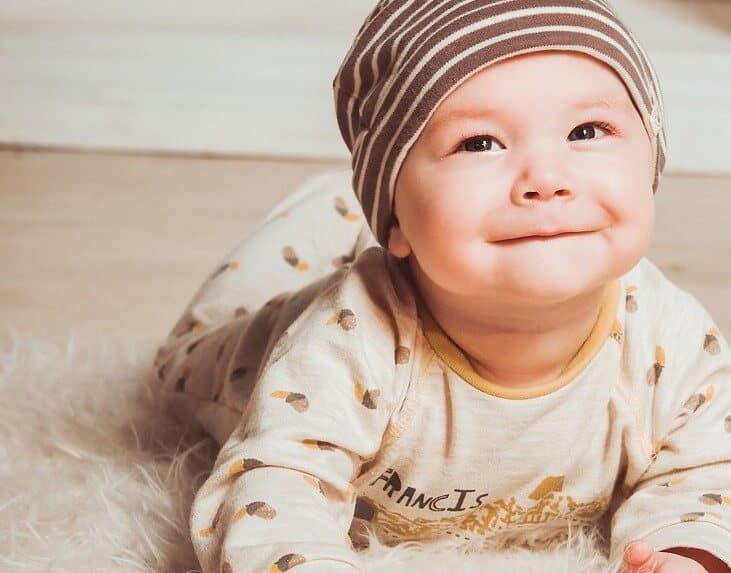 smiling baby crawling on the ground
